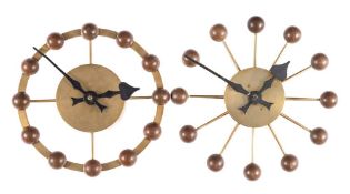 Two Synchronome electric brass sunburst wall clocks: the brass case with brass spokes at the hour