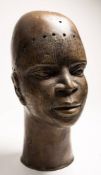 A 20th Century Benin bronze bust: of plain form 34cm high.