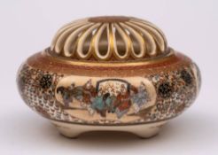 A Japanese satsuma tripod koro and cover: finely decorated in gilt and polychrome with panels of