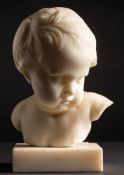 A 19th Century Italian white marble head and shoulders bust of a young child: looking to sinister,