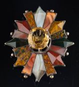 A late 19th century Scottish citrine and hardstone brooch,: the oval cut citrine in a claw setting,