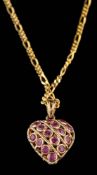 A ruby and sapphire pendant,: the heart shaped pendant set with circular cut rubies and sapphires,