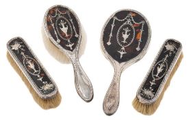 An Edward VII silver and tortoiseshell four piece dressing table set, maker William Comyns, London,