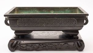 A Chinese bronze rectangular planter and a pewter two-handled bowl and cover: the planter with