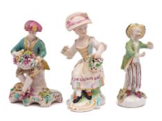 A group of three Derby figures: comprising a youth emblematic of Autumn holding a basket of fruit,