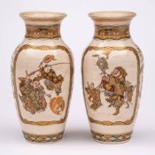 A pair of Japanese satsuma baluster vases: finely decorated with brocade bordered panels of dancing