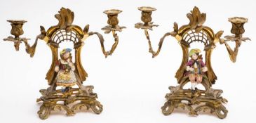 A pair of late 19th century ormolu and porcelain mounted twin light candelabra: of arched outline