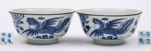 A pair of Chinese blue and white 'phoenix' bowls: each painted with a phoenix, peony and rockwork,
