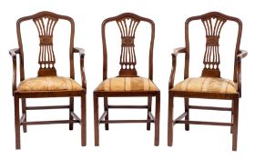 A set of four mahogany and upholstered dining chairs in Hepplewhite taste, 19th century,