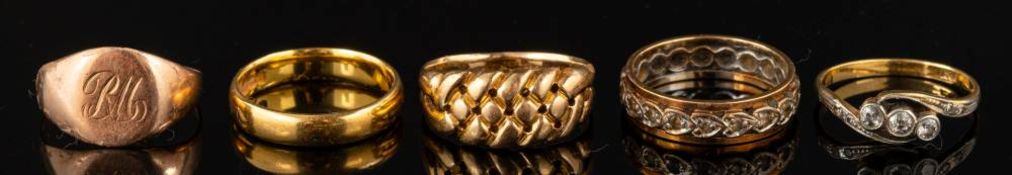A 22 carat gold ring,: of plain polished form,