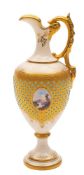 A Coalport 'jewelled' porcelain ewer: painted with a small lake landscape panel reserved on a