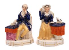 A pair of mid 19th Century Staffordshire porcelain seated figures: of 'Old Maid' and 'Old Bachelor',