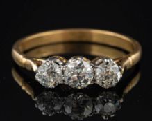 A diamond three stone ring,: set with three old brilliant cut diamonds, approximately 0.