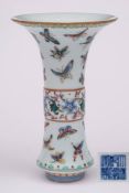 A Chinese famille rose beaker vase: enamelled with colourful butterflies and a band of scrolling