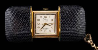 Verity, a travel clock,: in a black case, with a 9 carat gold chain.