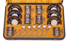 A Crown Staffordshire silver-mounted porcelain coffee set: decorated in gilt on a cobalt blue