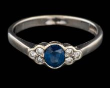 A 9 carat gold sapphire and diamond ring,: the oval cut sapphire between brilliant cut diamonds,