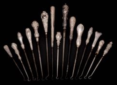 A collection of fifteen assorted silver-handled button hooks,