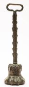 A 19th century brass door stop: modelled as a lion's paw with foliate decorated stem and handle,