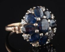 A sapphire and diamond cluster ring,: set with oval cut sapphires and old cut diamonds,
