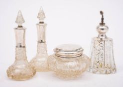 A pair of early 20th century clear cut glass and silver mounted scent bottles,