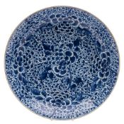 A Chinese blue and white 'peony' charger: painted overall with dense peony blooms and foliage,