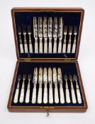 An early 20th century set of twelve plated fruit knives and twelve forks: with foliate engraved