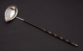 A late Georgian silver toddy ladle, unmarked: the oval bowl with monogram,