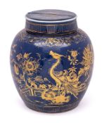 A Chinese blue ground ginger jar and cover: gilded with a large pheasant in a fenced garden with
