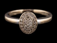 A diamond cluster ring: the oval panel set with brilliant cut diamonds, approximately 0.