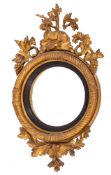 A George IV carved and giltwood framed convex wall mirror, circa 1825,