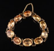 A foil backed topaz bracelet,: set with oval cut foil backed topaz, in pinched collet settings,