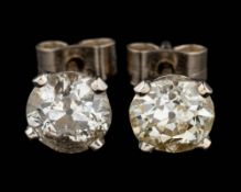 A pair of diamond ear studs,: each set with an old brilliant cut diamond, approximately 1.