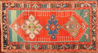 A Karabagh rug:, the red pointed field with triple geometric medallions,