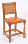 Workshop of Robert 'Mouseman' Thompson (Kilburn), an English oak panel back dining chair,