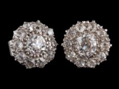 A pair of diamond cluster earrings,: the central old brilliant cut diamonds estimated to weigh 0.
