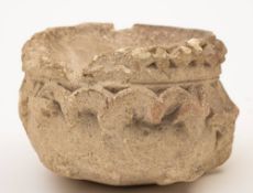 A stone stoup: with carved lozenge and bead decorated border, 15cm wide.