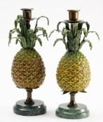 A pair of cold painted metal candlesticks: with urn-shaped sconces,
