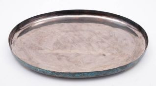 An Oriental silver tray: of plain oval form, raised on four block feet, 37.5cm wide, 852gms. 27.
