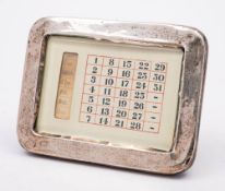 A silver cased perpetual calendar, maker's mark worn, Birmingham, 1915: 18cm wide.