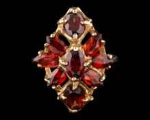 A garnet ring,: set with oval cut marquise cut and pear cut garnets, ring size N.