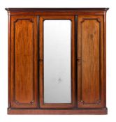 A Victorian mahogany three door wardrobe:, late 19th Century,