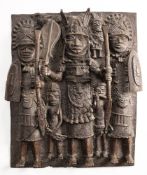 A Benin bronze plaque: cast in relief with Oba, flanked by warriors, 46 x 36cm.