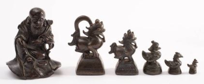 A set of five Chinese graduated bronze opium weights: in the form of mythical beasts,