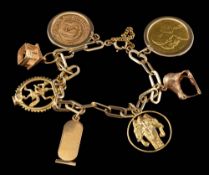 A gold coloured charm bracelet,: the polished link bracelet with various gold coloured charms,