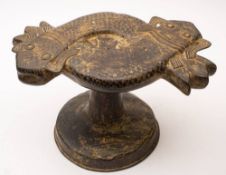 A Benin bronze stool in the form of an entwined catfish: raised on a tapering stem and circular