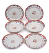 A set of four Chinese famille rose dishes and a pair of matching deep dishes: each painted with a