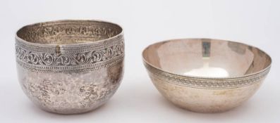 A Burmese silver circular bowl: with single band of scrolling and foliate decoration, 10cm diameter,