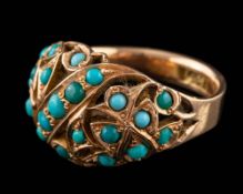 A gold coloured ring,: the openwork central section set with circular cabochon blue stones,