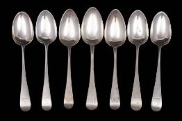 A matched set of seven silver Old English pattern dessert spoons, various makers and dates: 215gms,